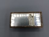 a silver and gold box with a picture of a woman on it