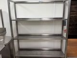 stainless steel shelvings in a commercial kitchen with a tiled floor