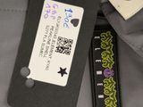 a label on the back of a backpack with a tag attached to it