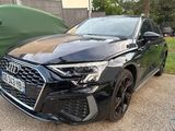 the front end of a black audi q3 parked in front of a green car