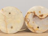 pair of white and brown marble lamps on a brown surface