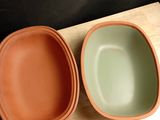 two bowls that are sitting on a wooden table