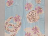 a blue towel with pink and white flowers on it