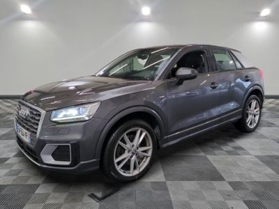 a grey audi suv parked in a garage