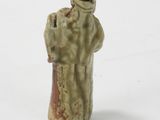 a figurine of a man and a woman on a white surface