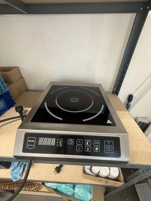a black and silver stove top on a wooden table