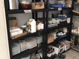 a room with a lot of dishes and pans on the shelves