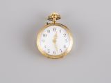 an image of a close up of a pocket watch on a gray surface