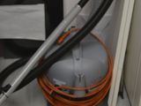 a vacuum that is sitting on the floor next to a cabinet