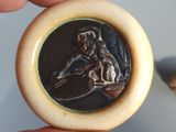 a person that is holding a small coin in their hand