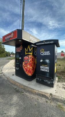 a pizza box that is sitting on the side of the road