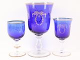three wine glasses sitting next to each other on a table