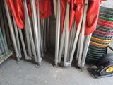 a lot of red cloths hanging on a rack