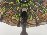 a close up of a lamp with a stained glass shade on it