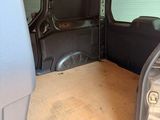 the interior of a van with the door open and a table in the back of the van
