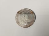 a close up of a coin on a white surface