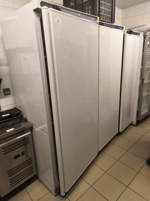 several refrigerators are lined up in a row in a kitchen