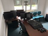 four computer monitors on a desk in a room