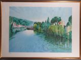 framed watercolor painting of a river scene with houses and trees