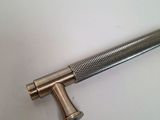 a close up of a metal handle on a white surface