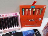 a lot of pens and a box on a table