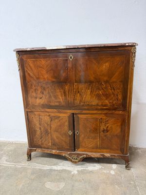 a wooden cabinet with two doors and a drawer on it