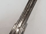 a silver spoon that is on a white table