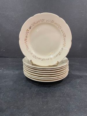 six white plates stacked on top of each other on a table