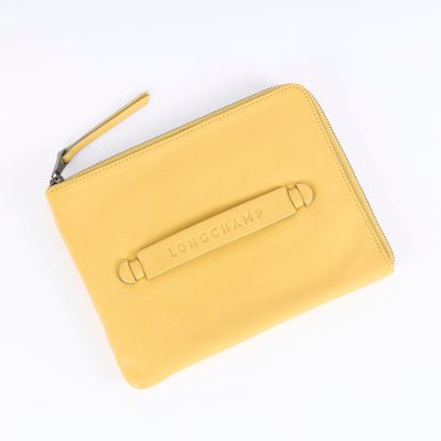 the yellow leather wallet is open on a white surface