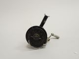 a close up of a small metal object on a white surface