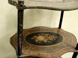 a three tiered table with a decorative design on it