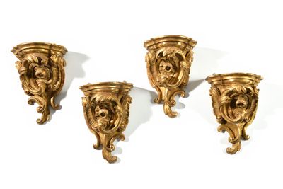 three gold colored wall sconces with a lion head on each of them