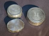 three tins that are sitting on a table
