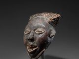 a close up of a sculpture of a head on a stand