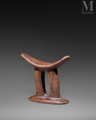 an image of a wooden stool with a curved seat