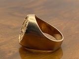 a gold ring sitting on top of a wooden table