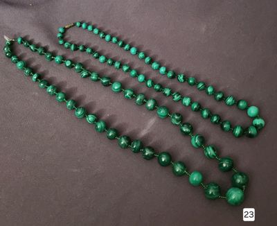 a close up of a green beaded necklace on a table