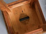 a wooden chair with a hole in the middle of it