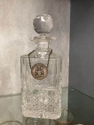 a bottle of perfume sitting on top of a glass table