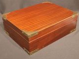 an image of a wooden box with brass trimming on it
