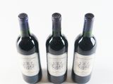 three bottles of wine sitting next to each other on a table