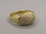 an image of a gold and diamond ring on a white surface