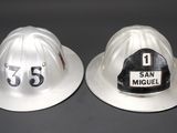 two white fire hats with the number 53 and the number 53 on them