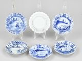 several blue and white plates and bowls are arranged in a circle