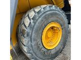 a close up of a yellow wheel on a construction vehicle