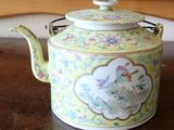 a tea pot sitting on a table in a room