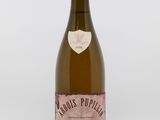 a bottle of wine sitting on top of a white table