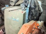 a pile of trash in a room with a fire hydrant next to it