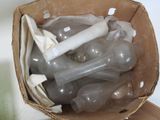 a cardboard box filled with a bunch of bottles and bones