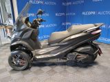 a picture of a scooter parked in a showroom